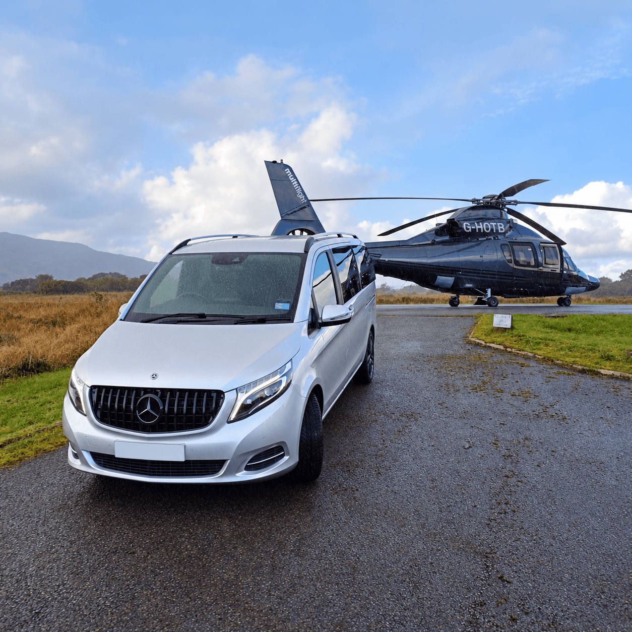 Mercedes-Benz vehicle with a helicopter in the background